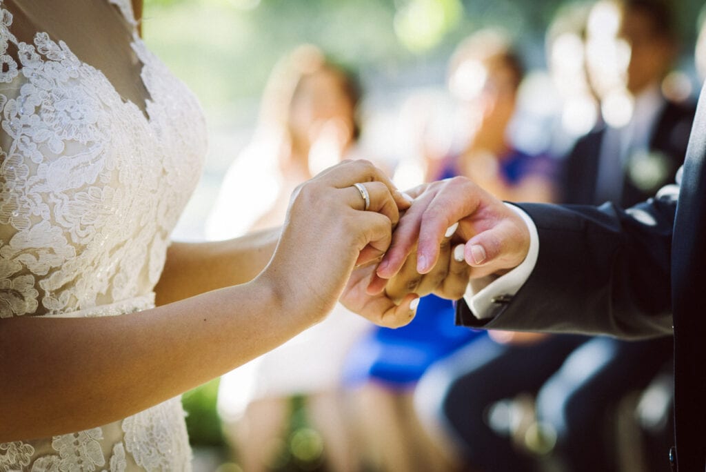 ring exchange at a lakeside wedding