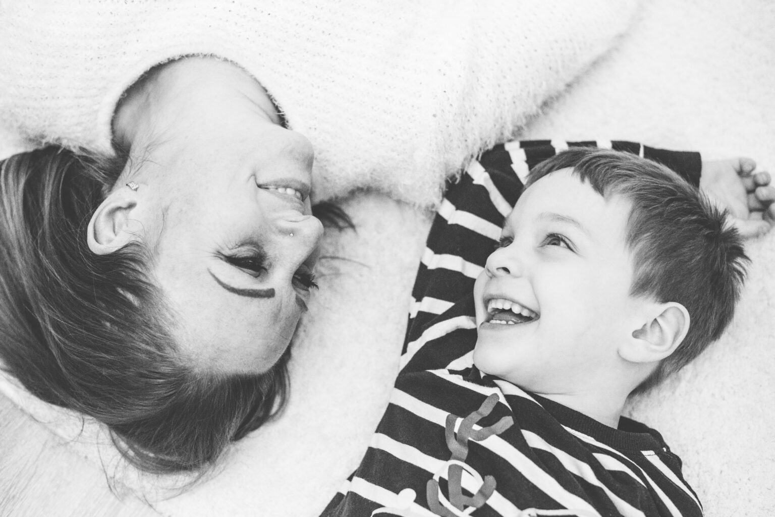 the mum and her little boy is hanging on the floor on their family portrait session