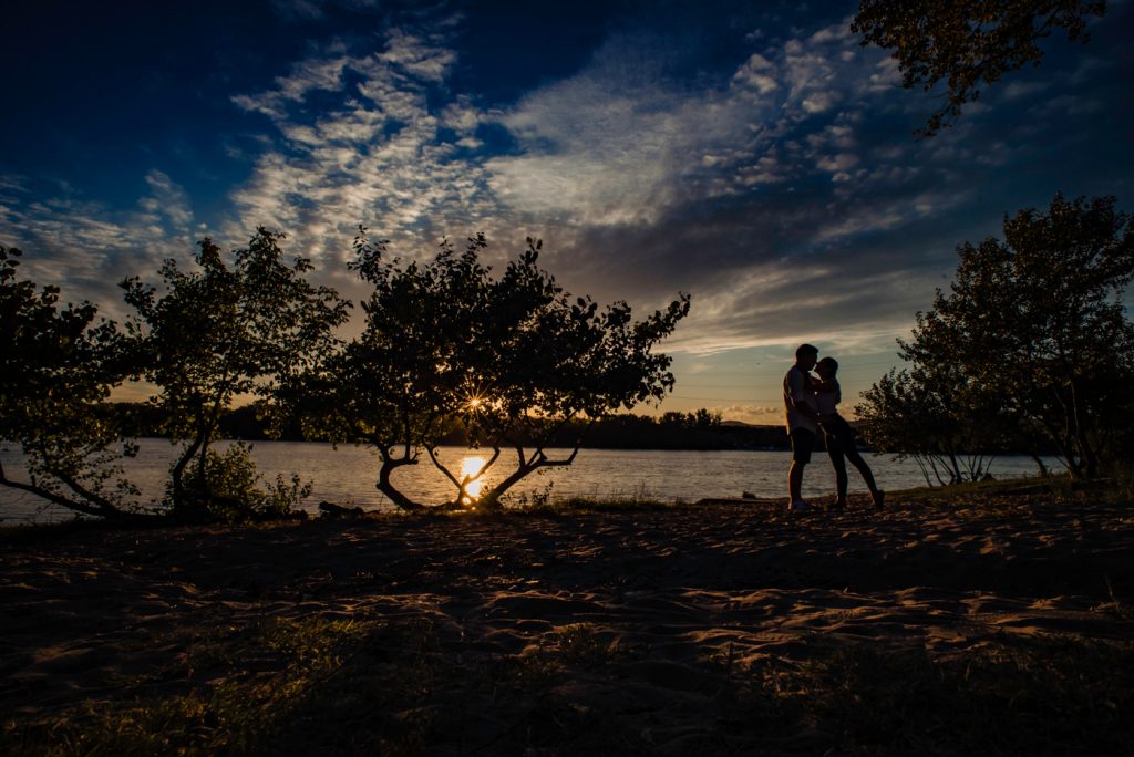 engagement photo session in the sunset with silhouette of the couple