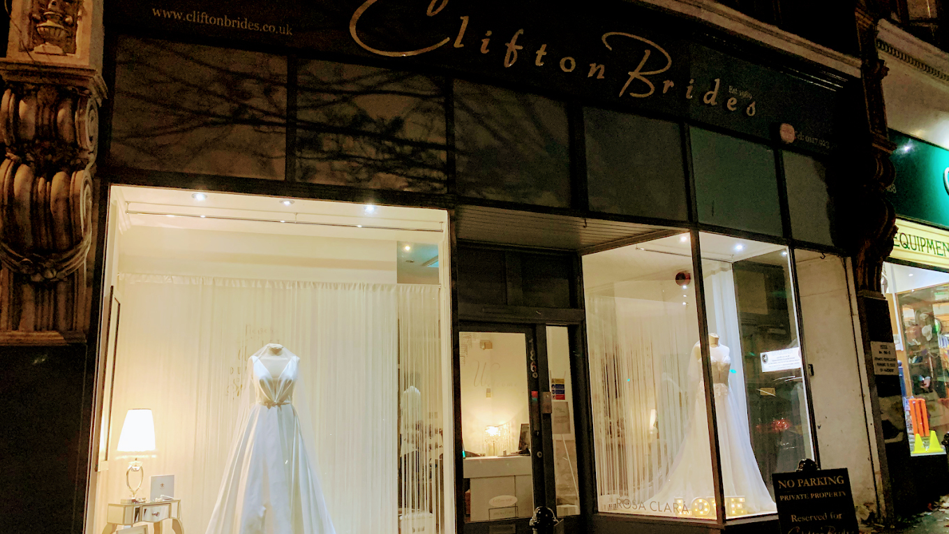 Clifton Brides bridal boutique storefront in Bristol displaying wedding dresses in illuminated shop window.