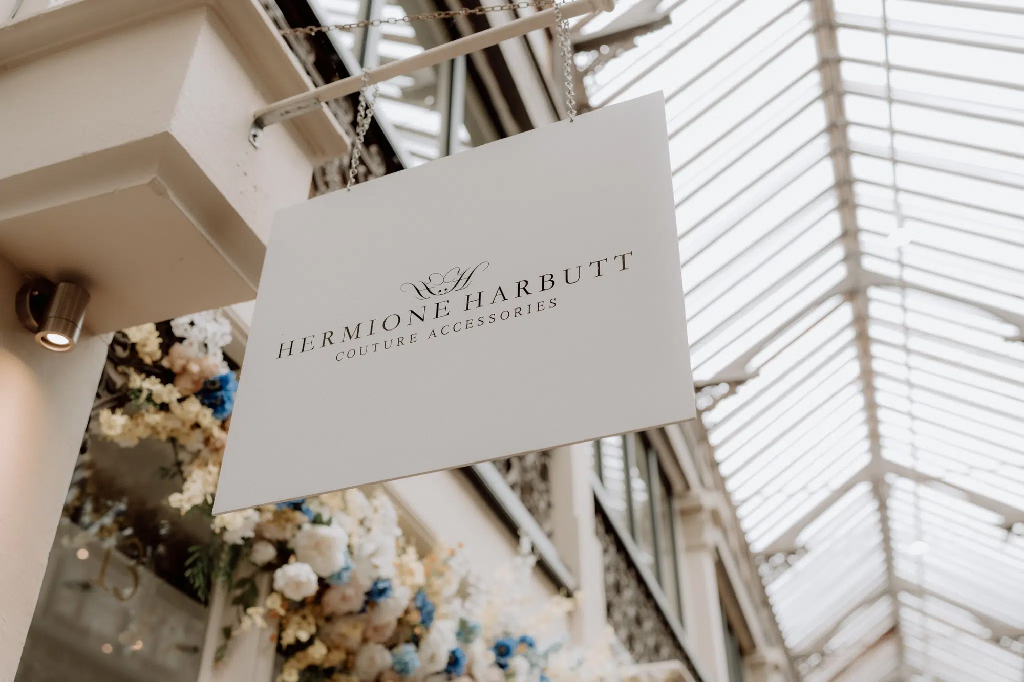 Hermione Harbutt couture accessories sign displayed inside elegant bridal showroom in Bristol.