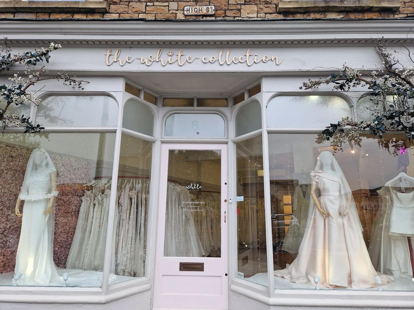 The White Collection bridal boutique in Bristol with wedding dresses displayed in large shop windows.