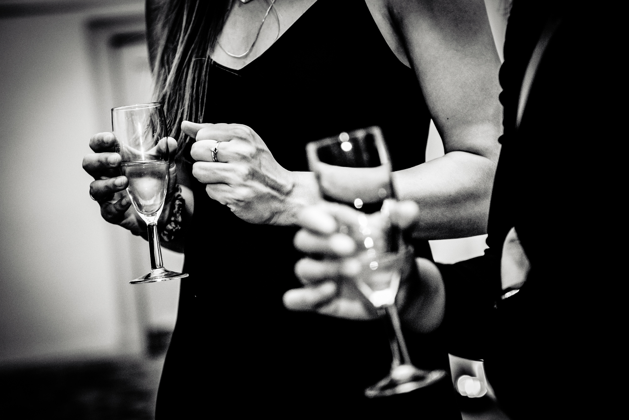 Black and white photo of guests holding champagne glasses during the Bristol awards evening.