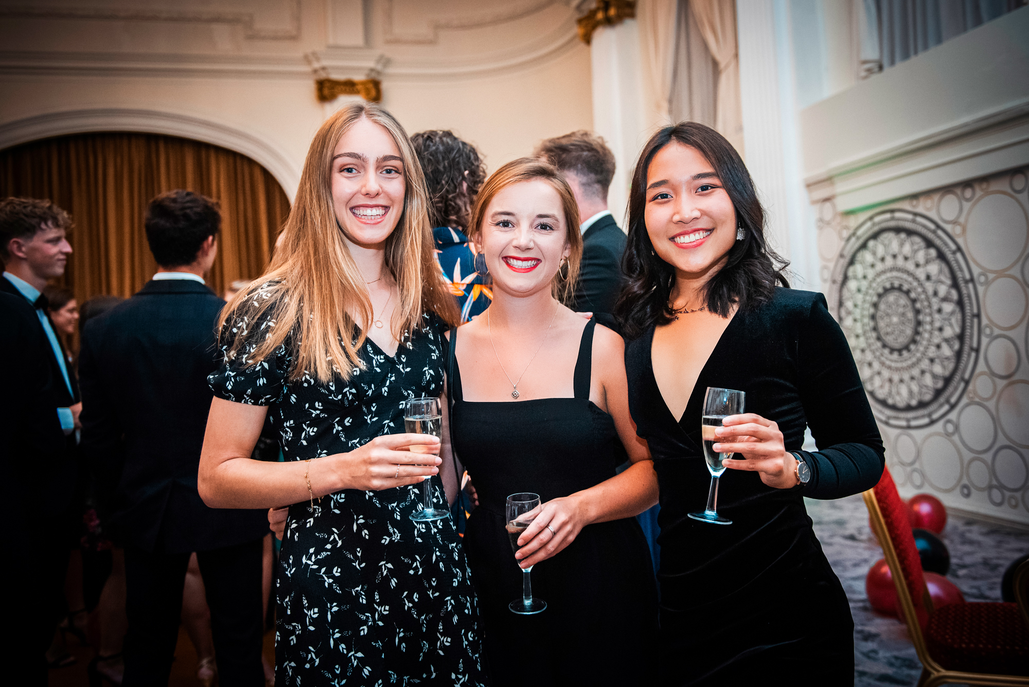 Three guests posing together during the Bristol Grand Hotel gala dinner reception.