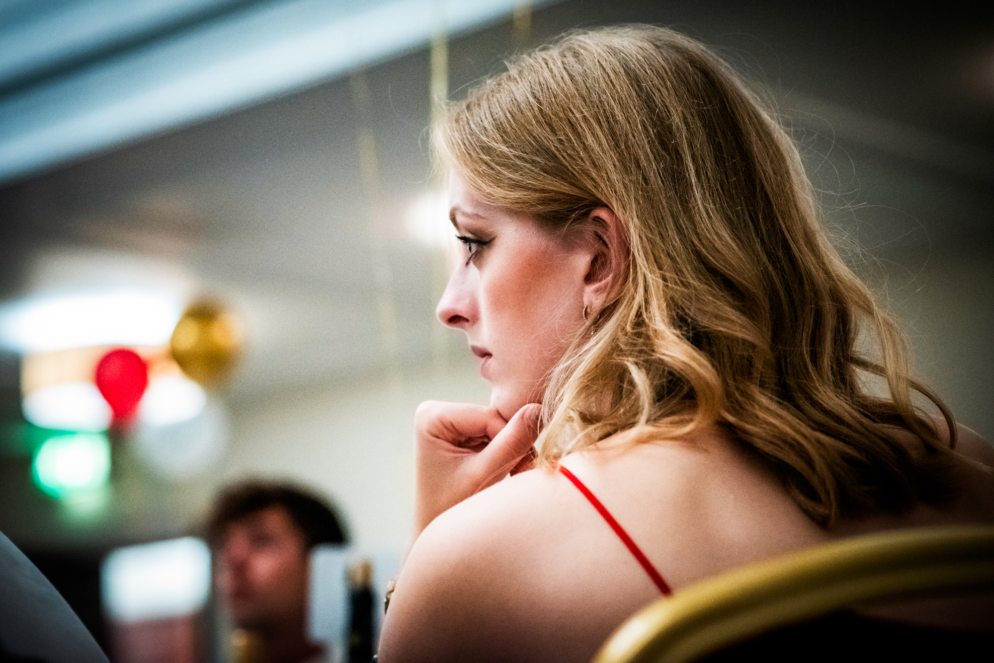 Blonde guest listening during the Galenicals Awards dinner reception in Bristol.