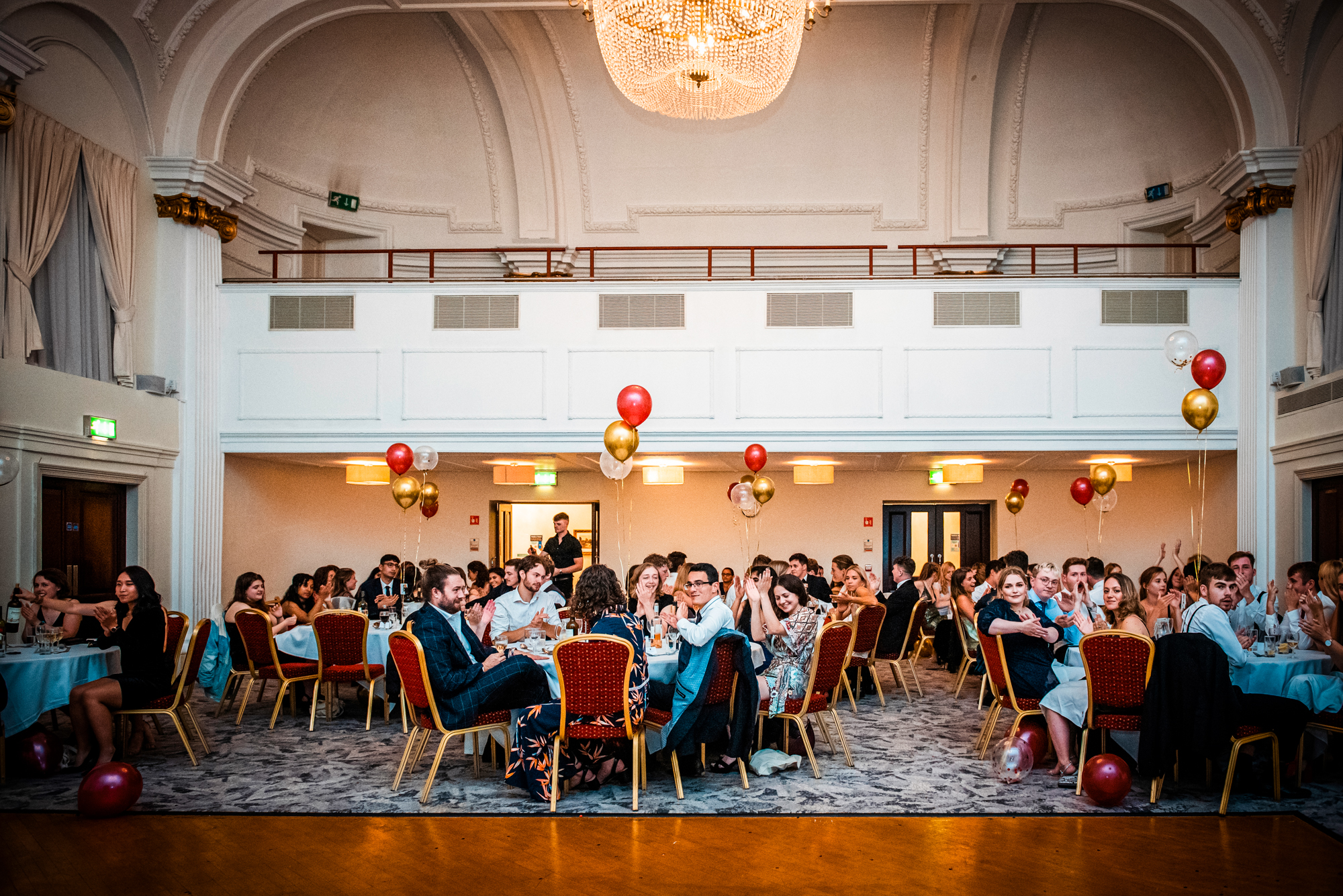 Wide view of the Galenicals Awards banquet hall decorated with balloons and chandeliers in Bristol.