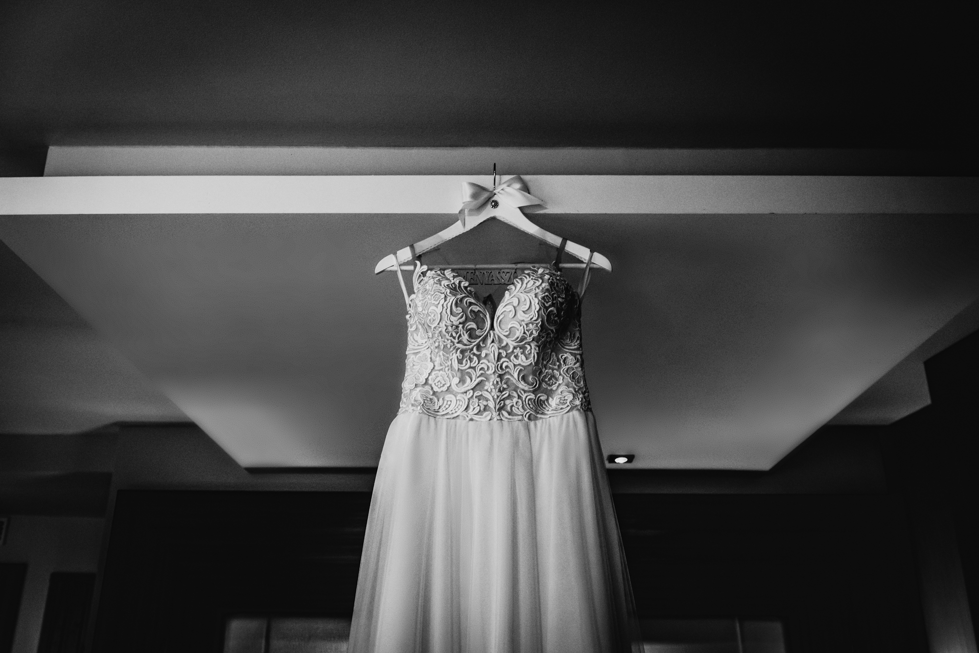 Lace wedding dress hanging in the bridal suite before the Budapest wedding ceremony.