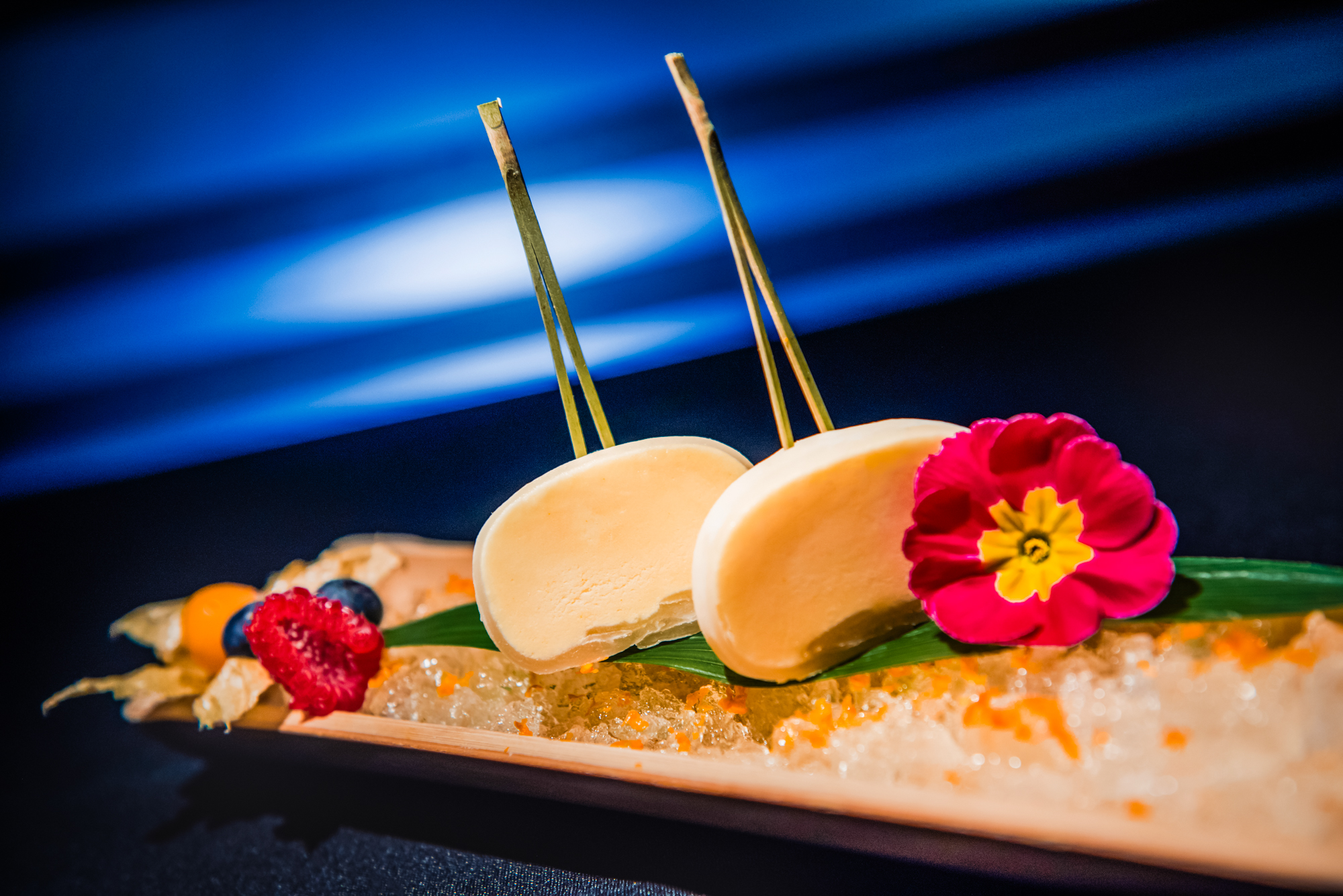 Frozen dessert bars served on crushed ice with berries and edible flower decoration at Nobu Budapest.