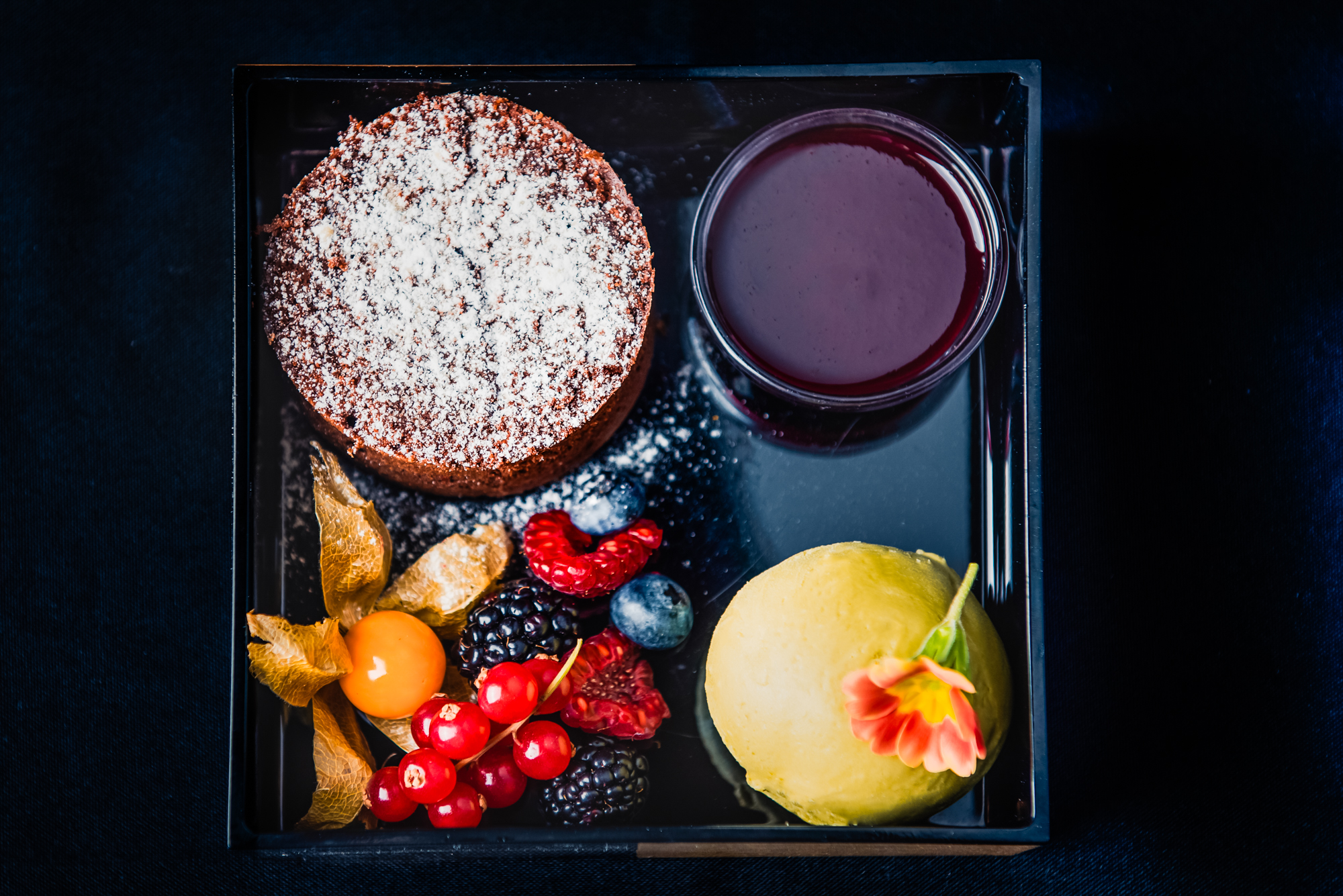 Chocolate fondant with berry coulis, sorbet, and fresh seasonal berries.