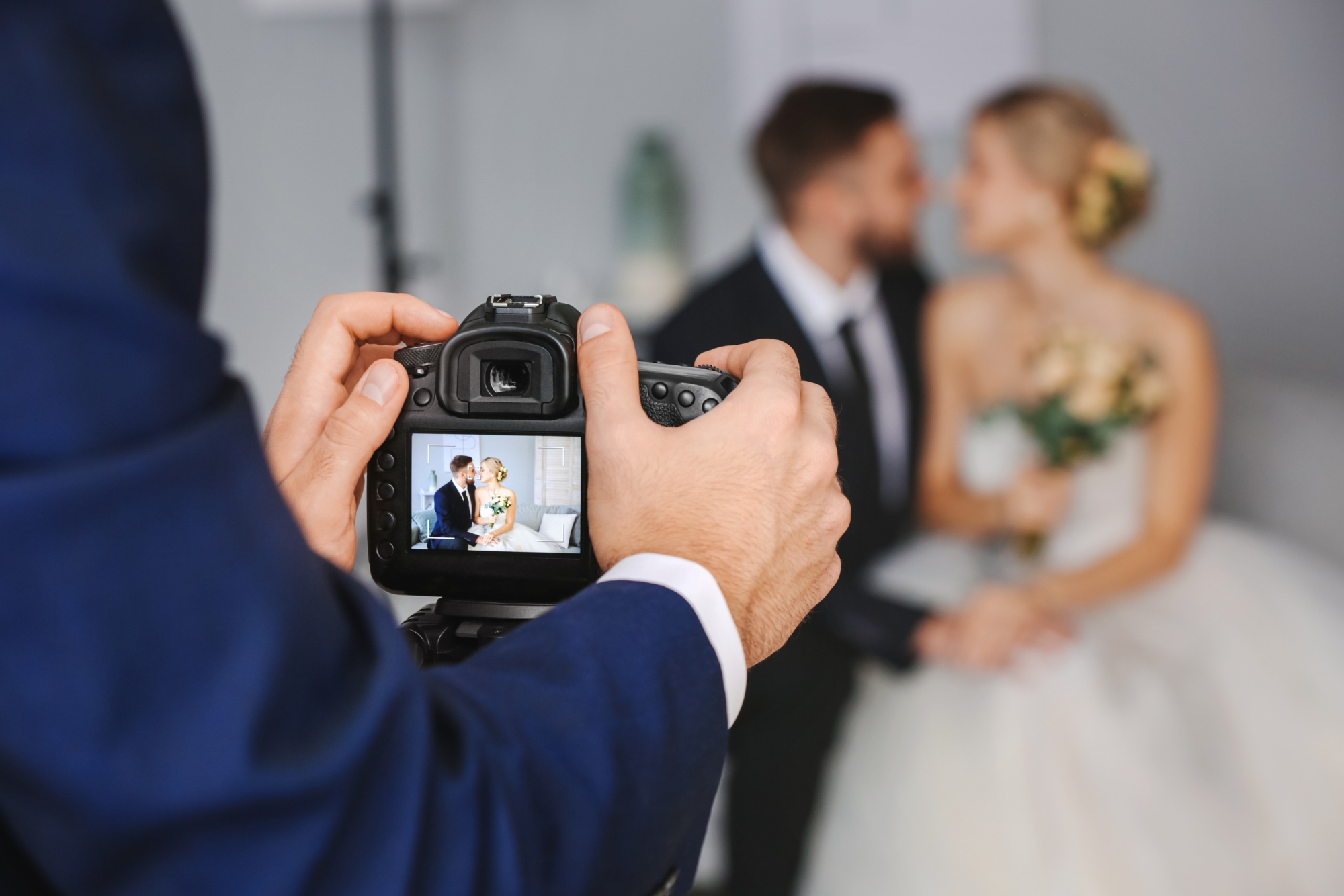 Wedding photographer capturing a couple indoors, showing how moments are framed through one camera.
