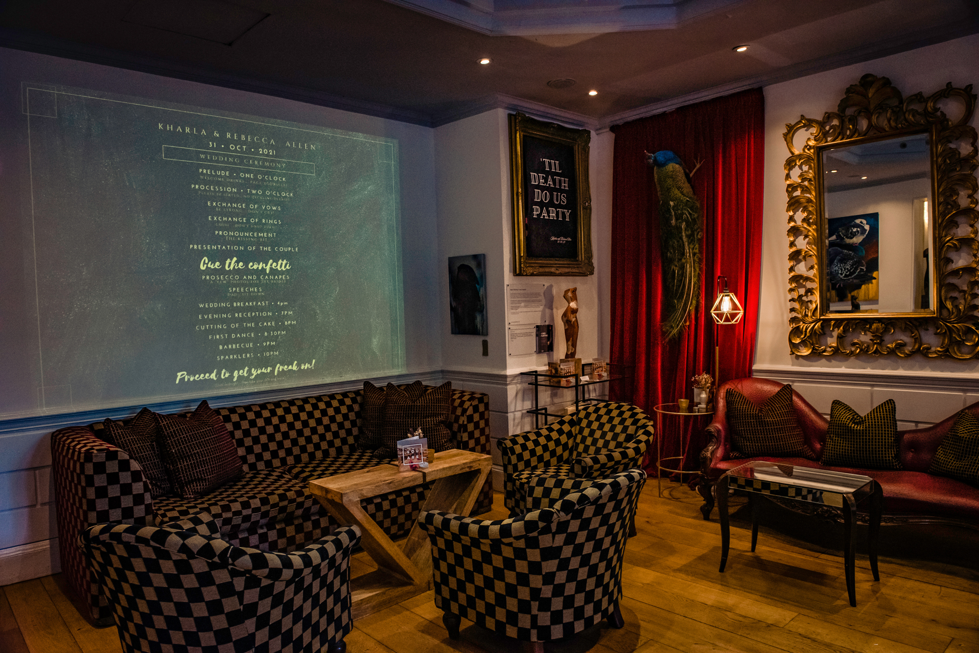 Cosy lounge at The Square Club Bristol with wedding schedule projected on the wall and eclectic decor.