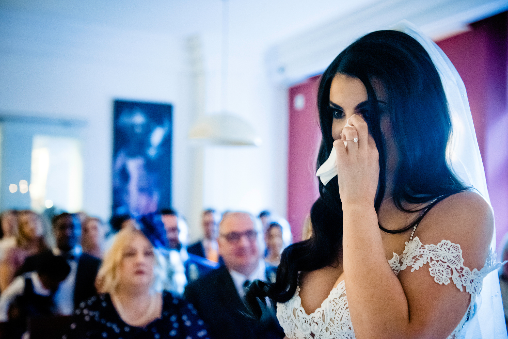 Bride wiping away happy tears during the vows.