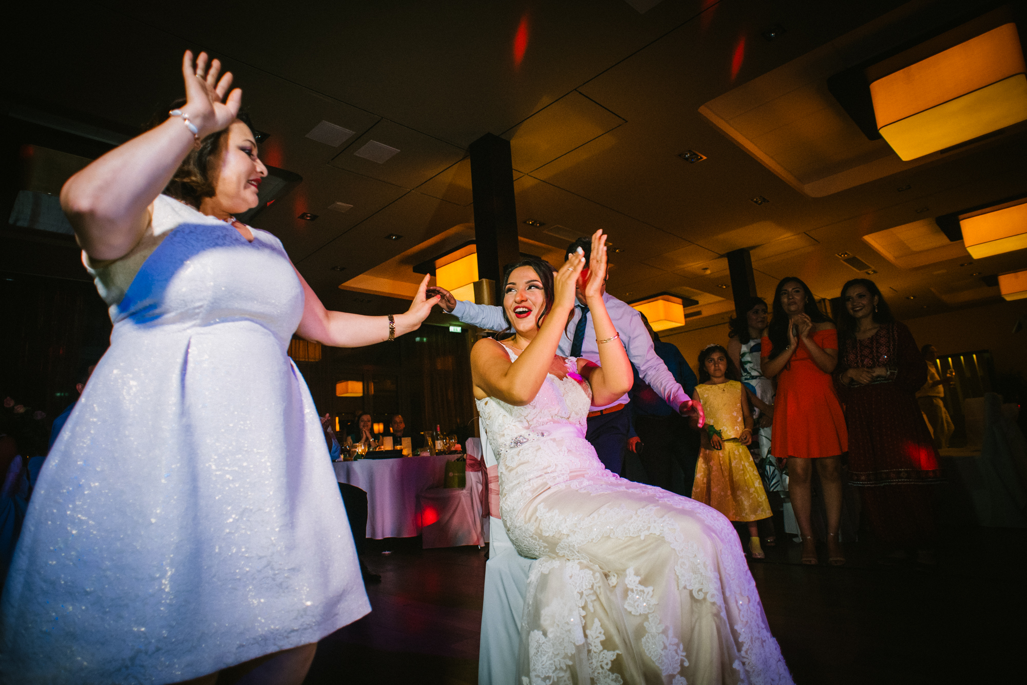 ride seated and dancing while guests cheer around her during lively reception.