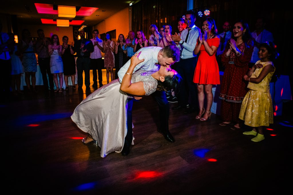 Romantic moment of the groom kissing the bride on the dancefloor after their first dance.