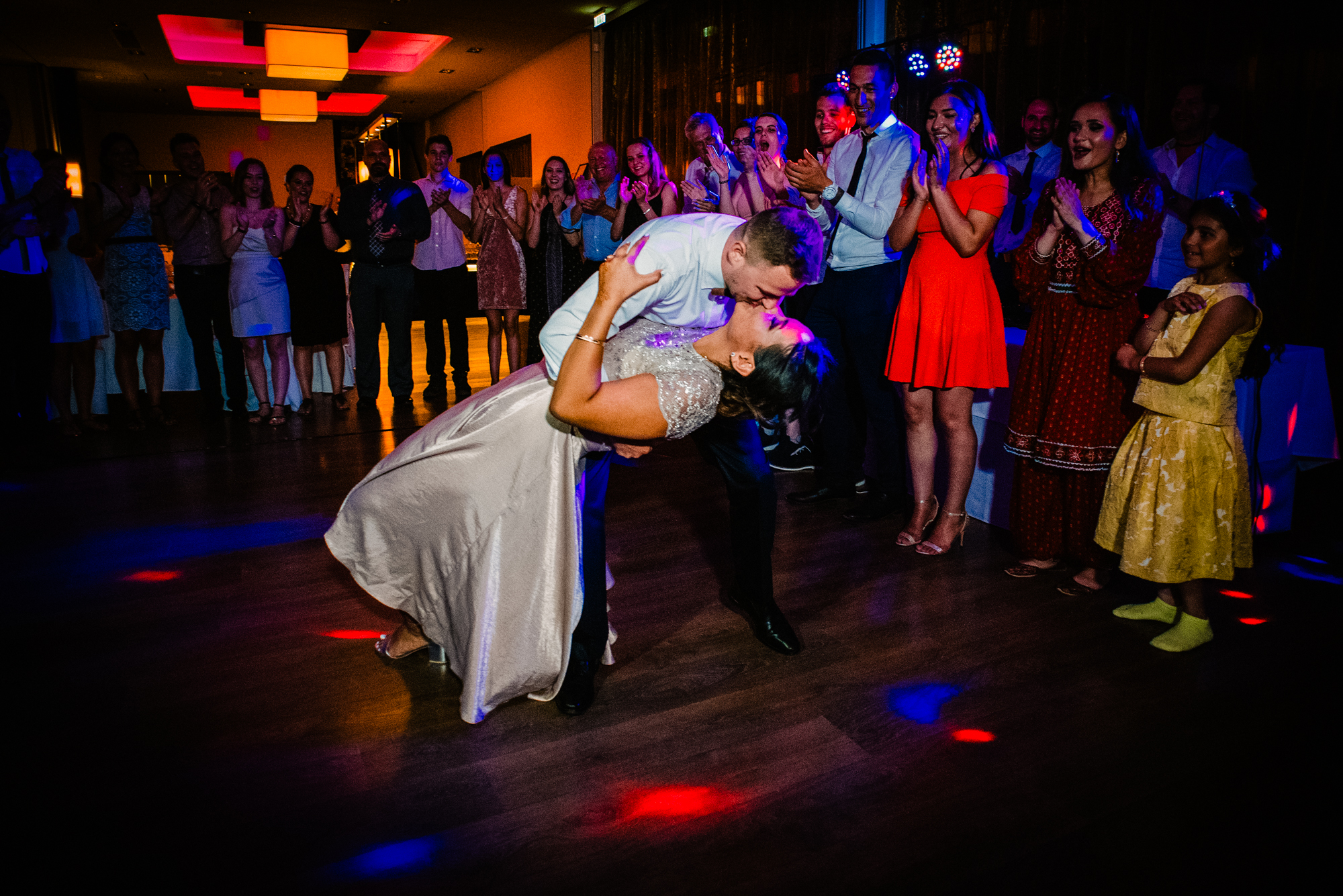 Romantic moment of the groom kissing the bride on the dancefloor after their first dance.