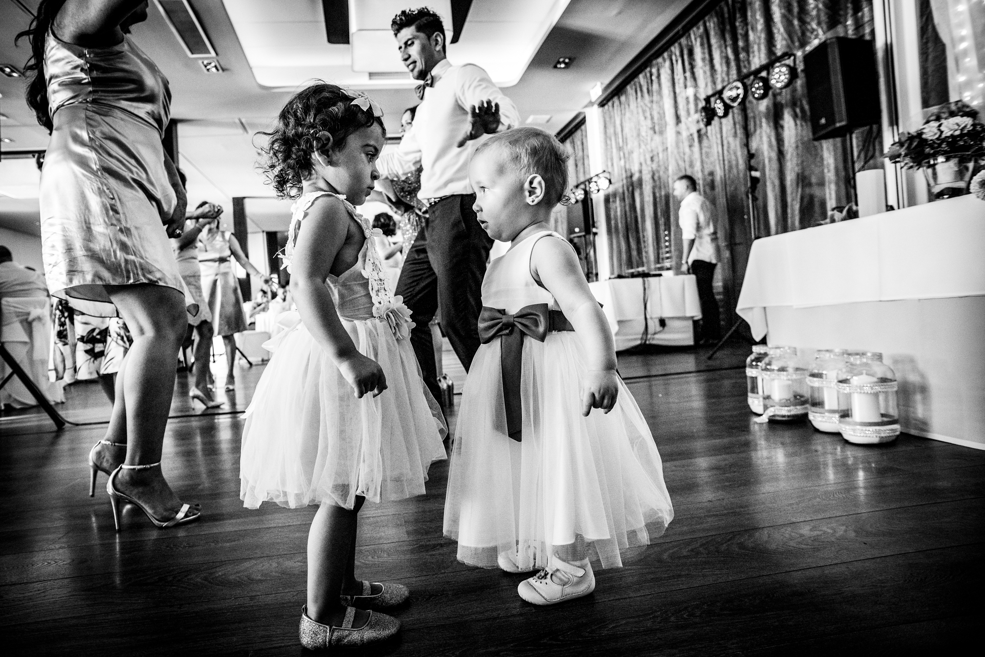 Two young girls facing each other on dance floor.