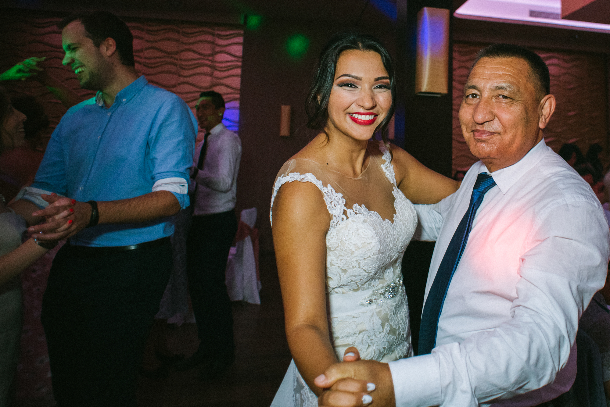 Bride dancing with her dad on lively wedding dance floor in Budapest reception venue.