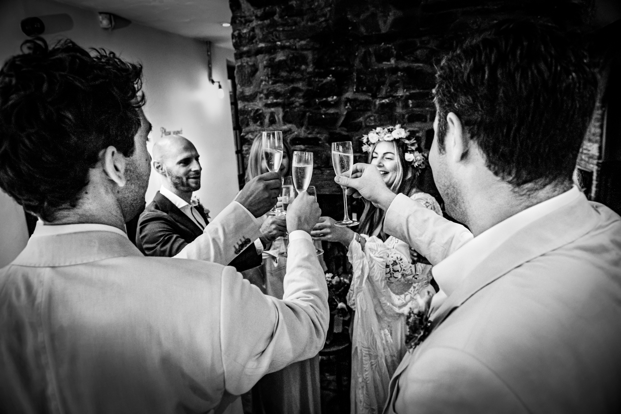Guests raising glasses together in intimate celebration moment inside Christmas Steps Pub in Bristol.