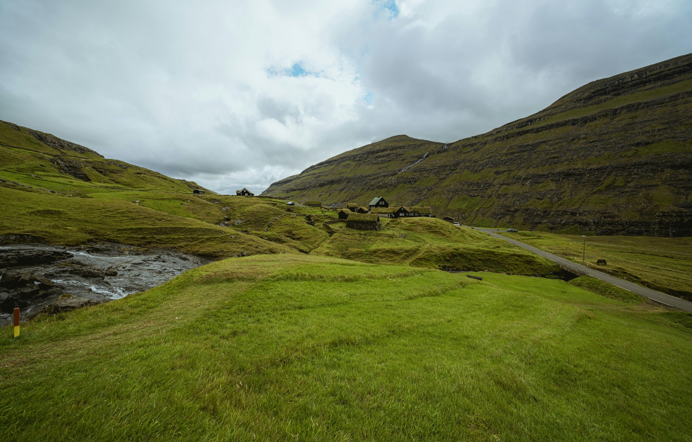 Traditional stone houses nestled in the green valleys of Scotland, a remote and romantic landscape for eloping in the UK.