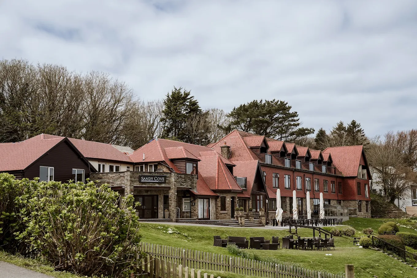 Sandy Cove Hotel in Devon with red rooftops and coastal charm, a stunning seaside venue for couples eloping in the UK.
