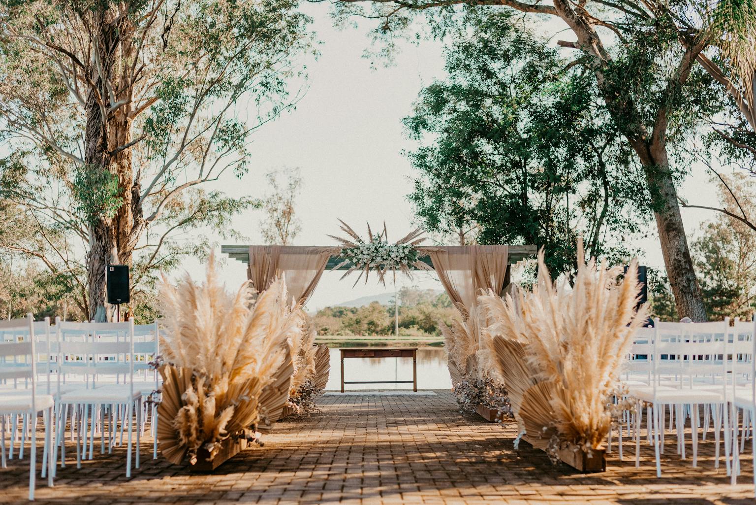 Beautiful outdoor wedding venue with elegant decorations and lake view.