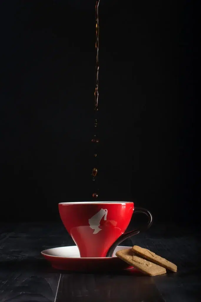 Coffee pour and biscuit scene styled for commercial product photography in Bristol