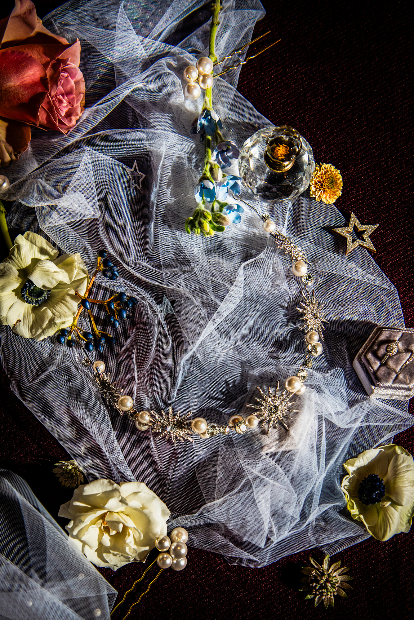 Pearl and crystal bridal accessories styled on soft tulle with winter florals.