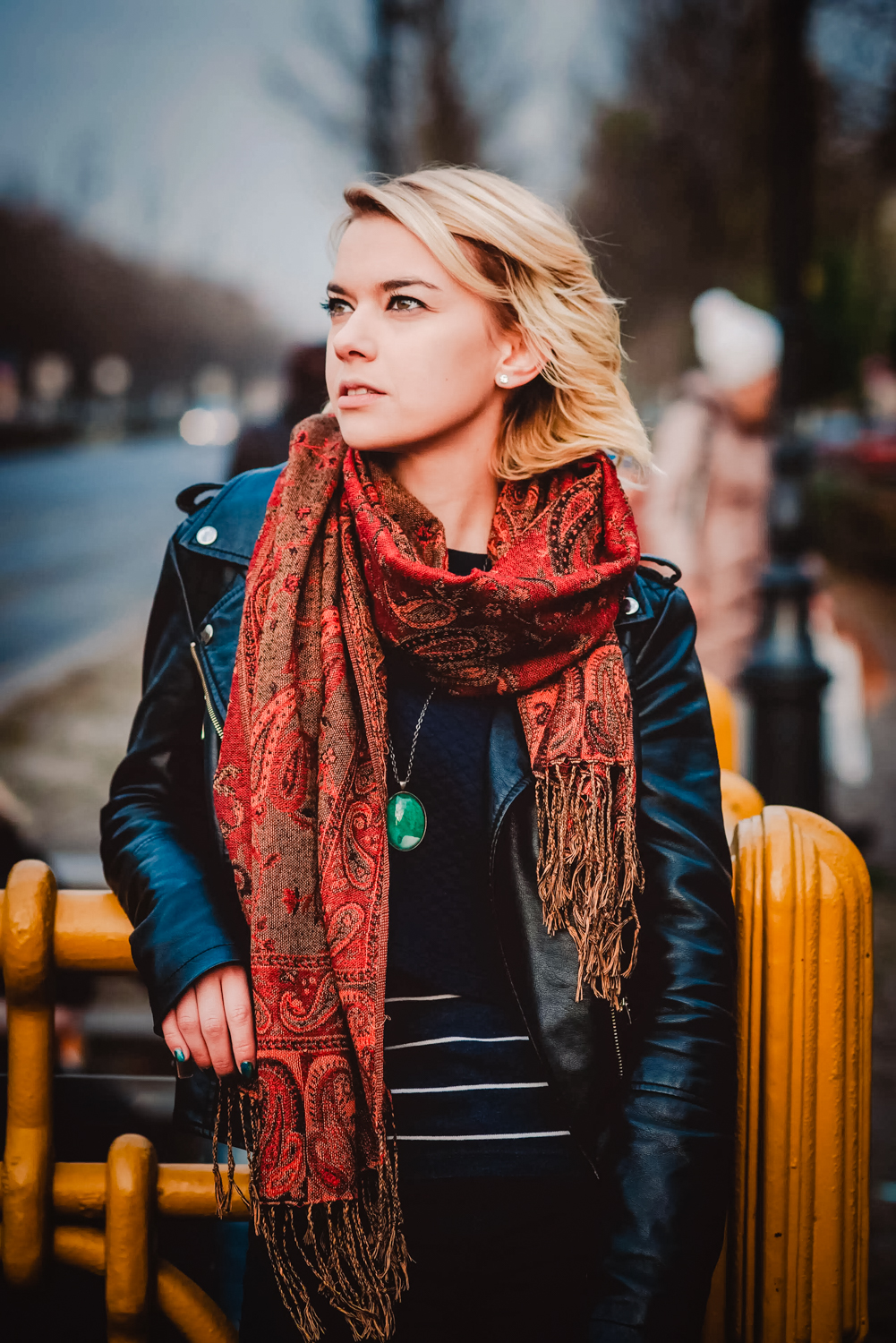 Eszter Szalai, the owner of Emerald Photo UK is wearing leather jacket and patterned scarf.