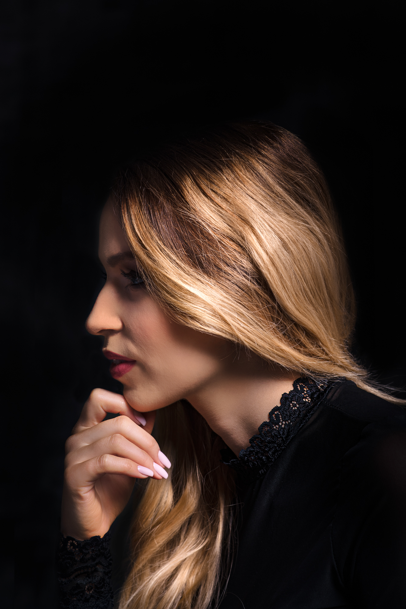 Side profile from a studio portrait session with soft light on blonde hair.