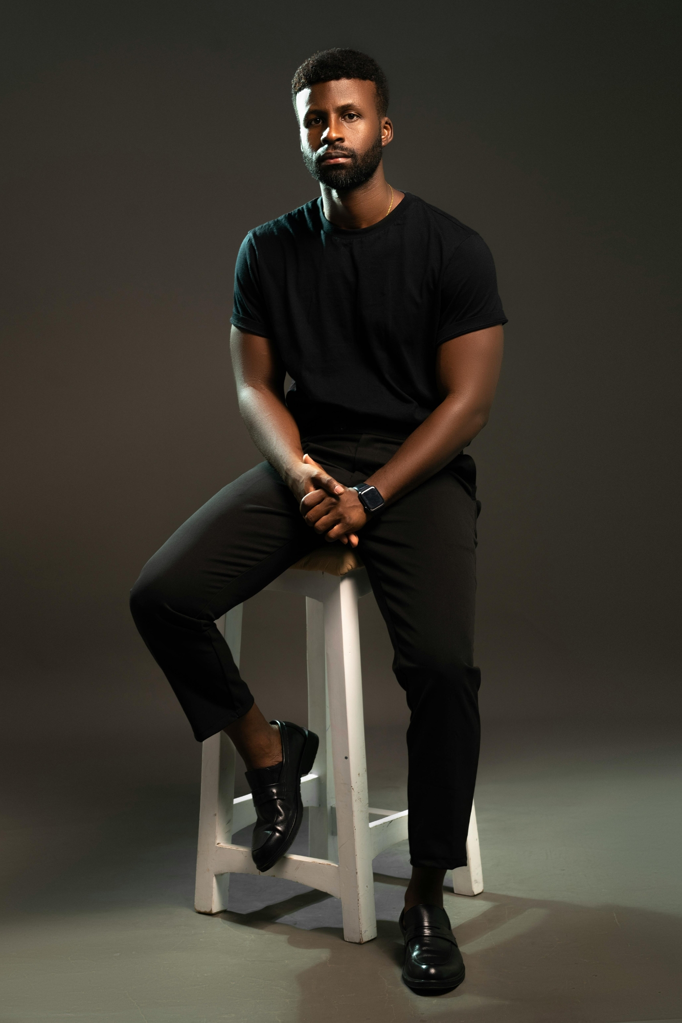 Man dressed in all black outfit with loafers, simple professional look suitable for wedding photography.