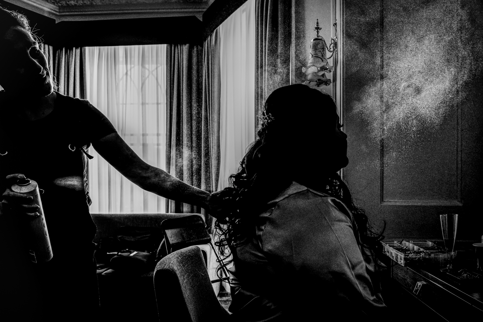 Artistic hairspray moment during bridal prep at Arnos Manor Hotel Bristol.