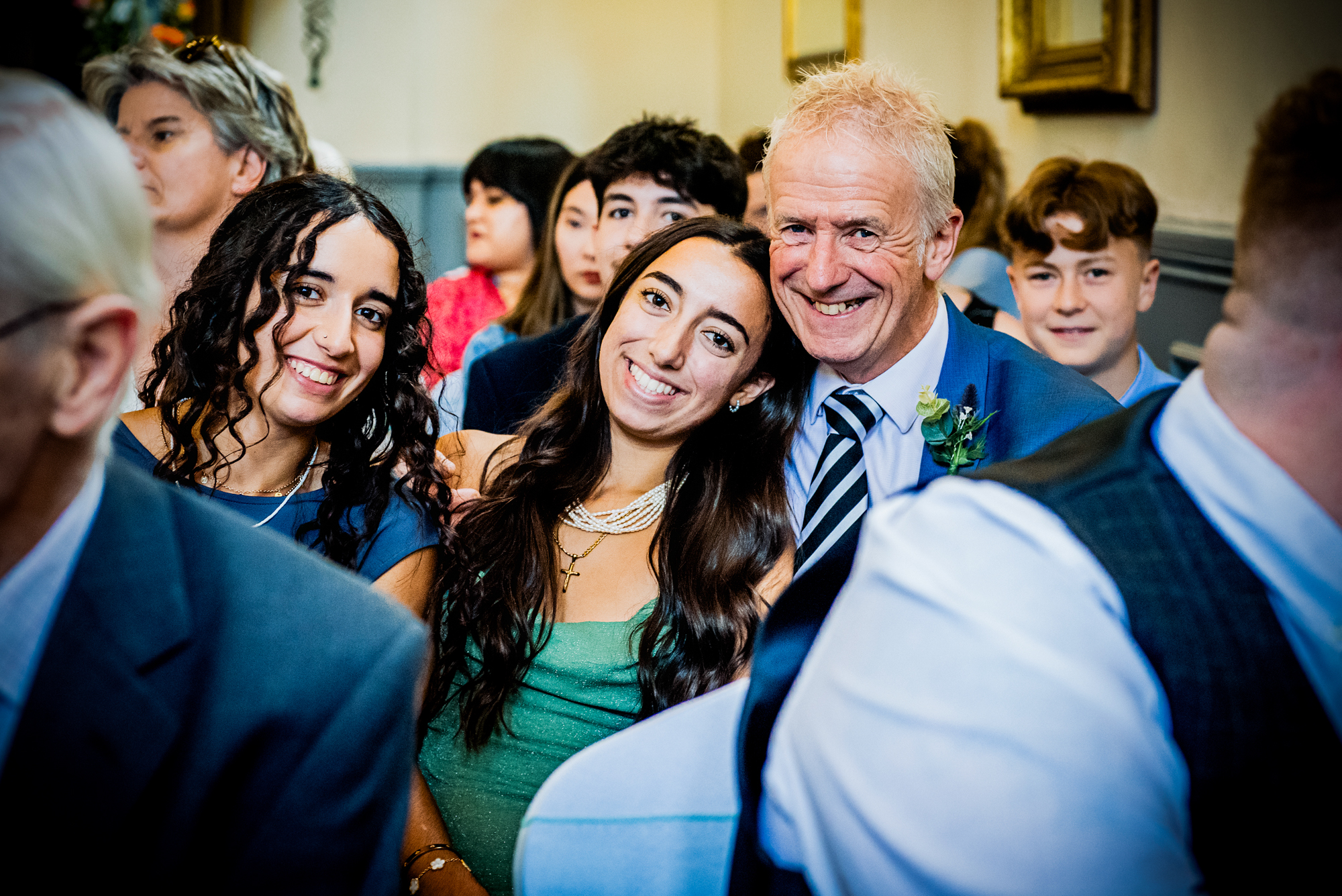 Wedding guest are smiling at a multicultural wedding at Arnos Manor Hotel in Bristol.