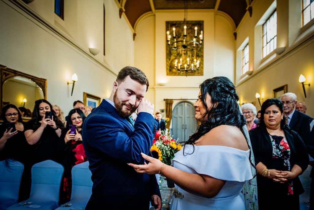 Emotional moment as groom wipes tear during ceremony at Arnos Manor Hotel.