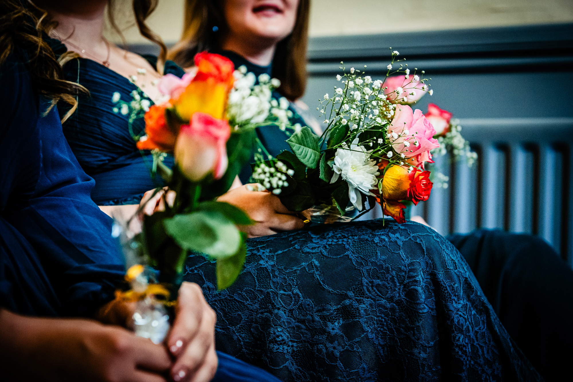 Bridesmaids holding colourful bouquets during ceremony at Arnos Manor Hotel.