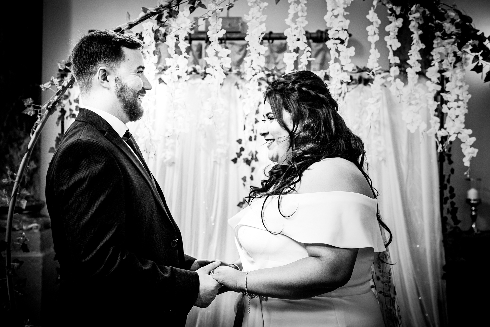 Candid of couple smiling during ceremony at Arnos Manor Hotel wedding.