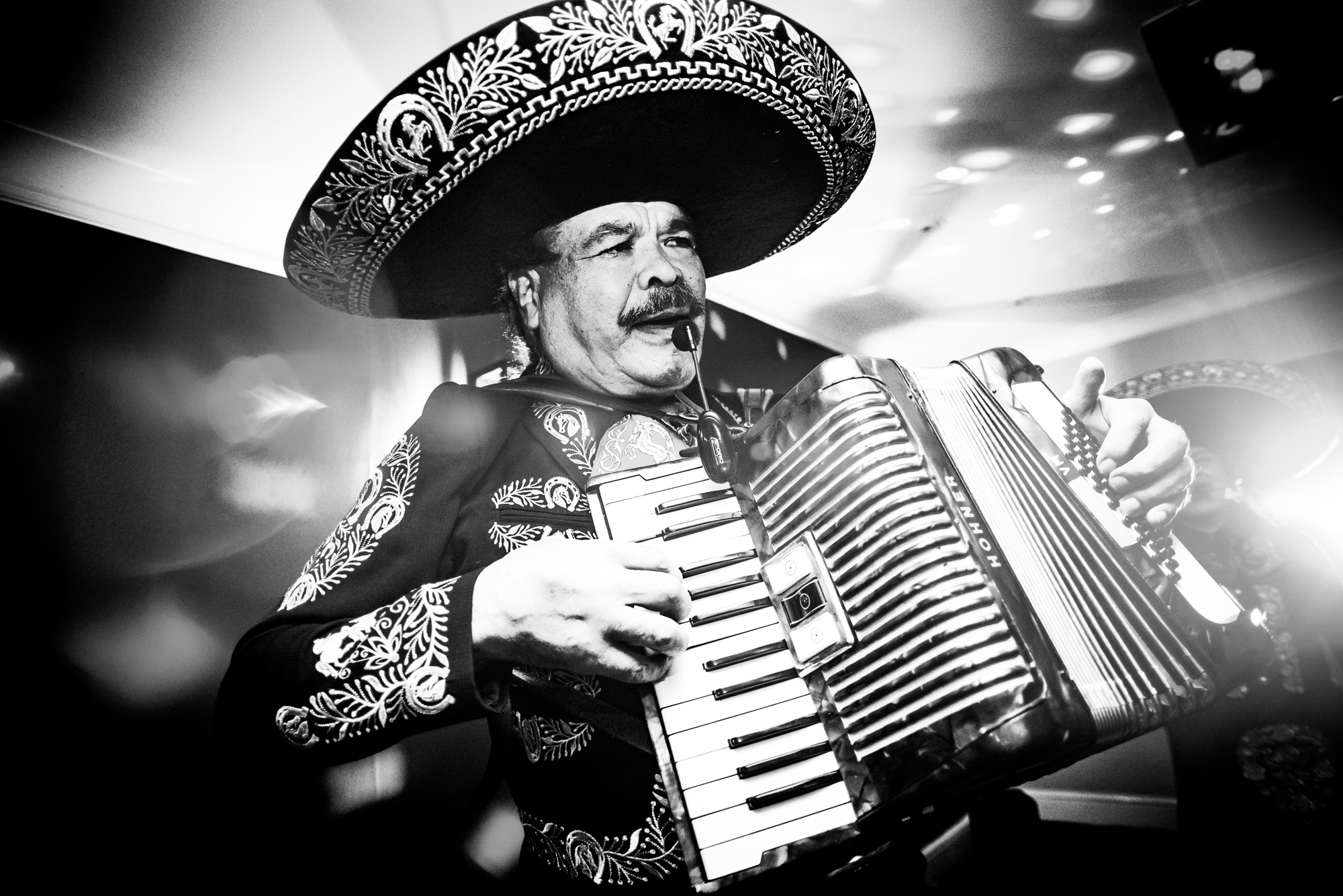 Accordion player performing at lively wedding celebration at Arnos Manor Hotel in Bristol.