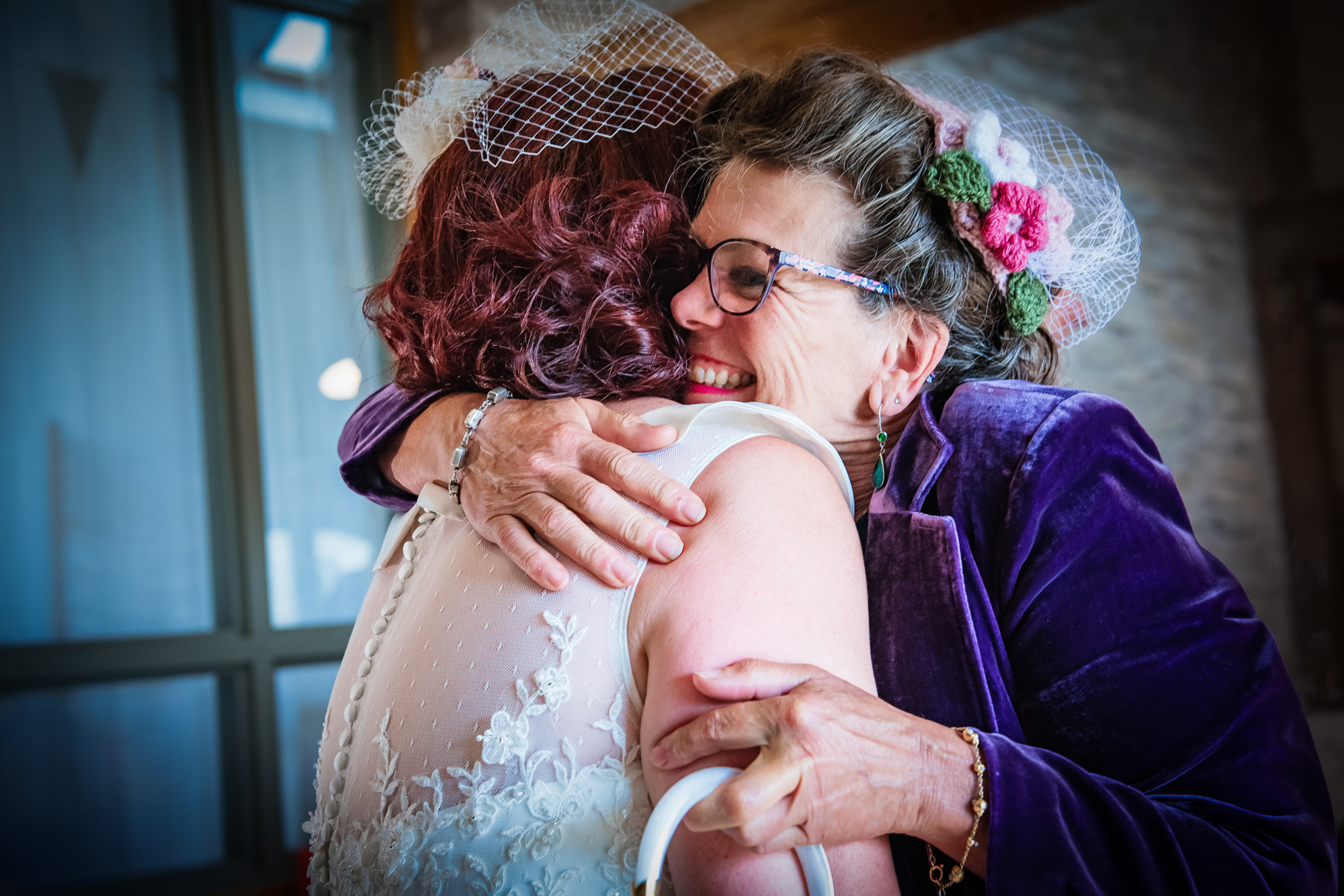 Bride hugging her relative during unposed morning preparations in documentary wedding photography style.