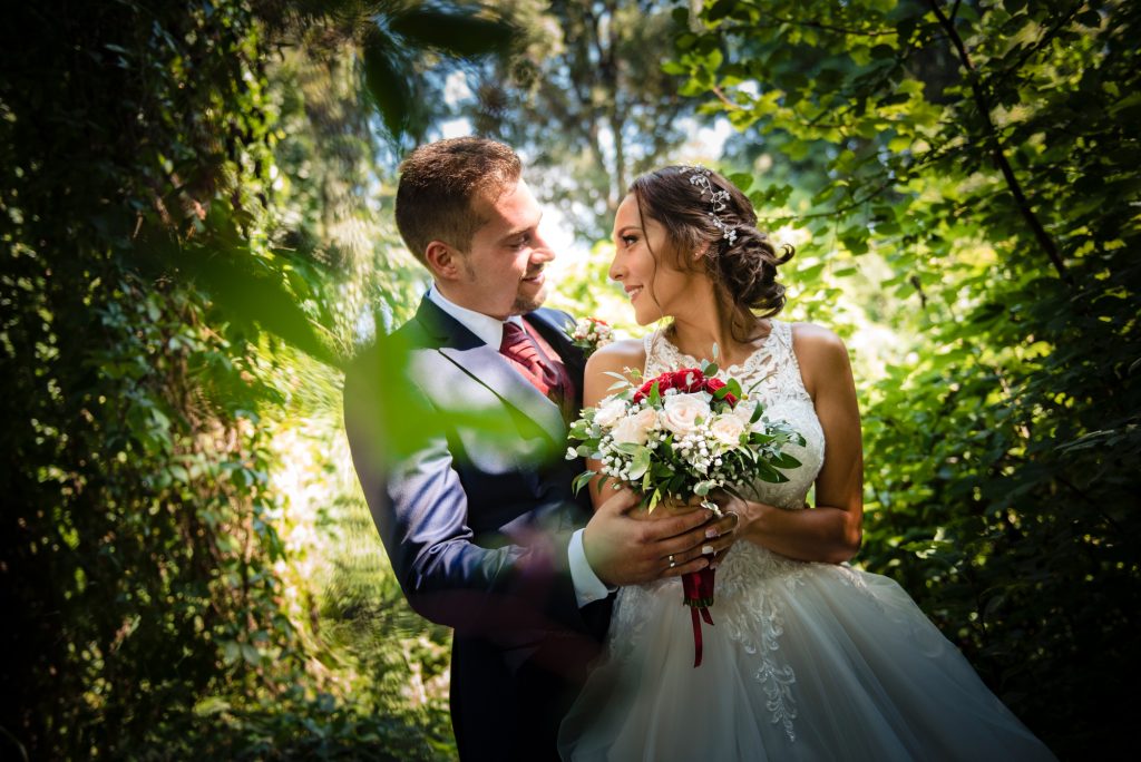 Bride and groom portrait in forest light, romantic Hungarian wedding couple moment.