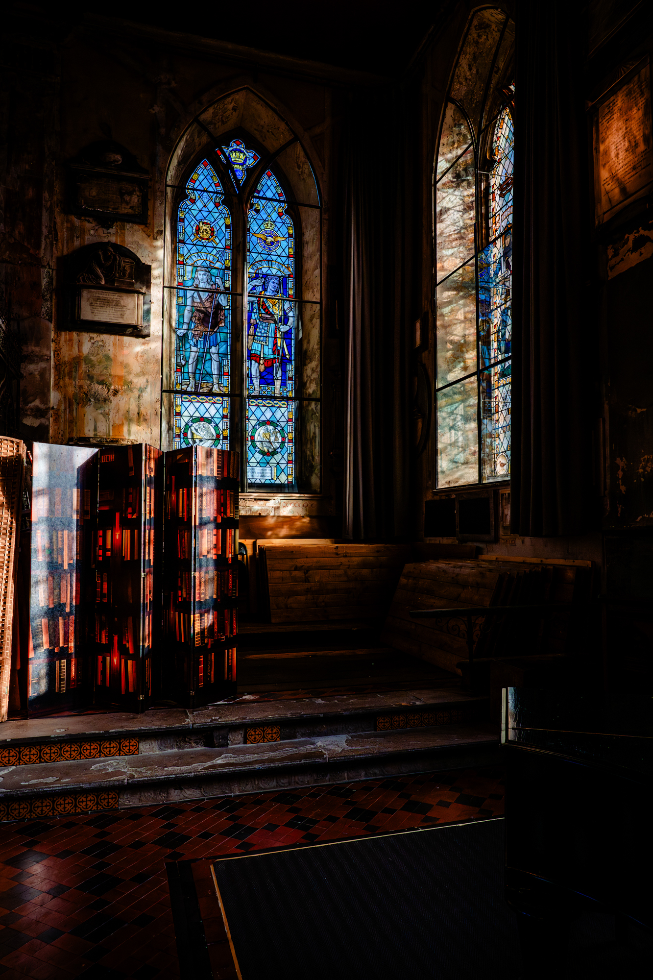 Moody church interior with dramatic light and vintage book installation at Bristol wedding venue.