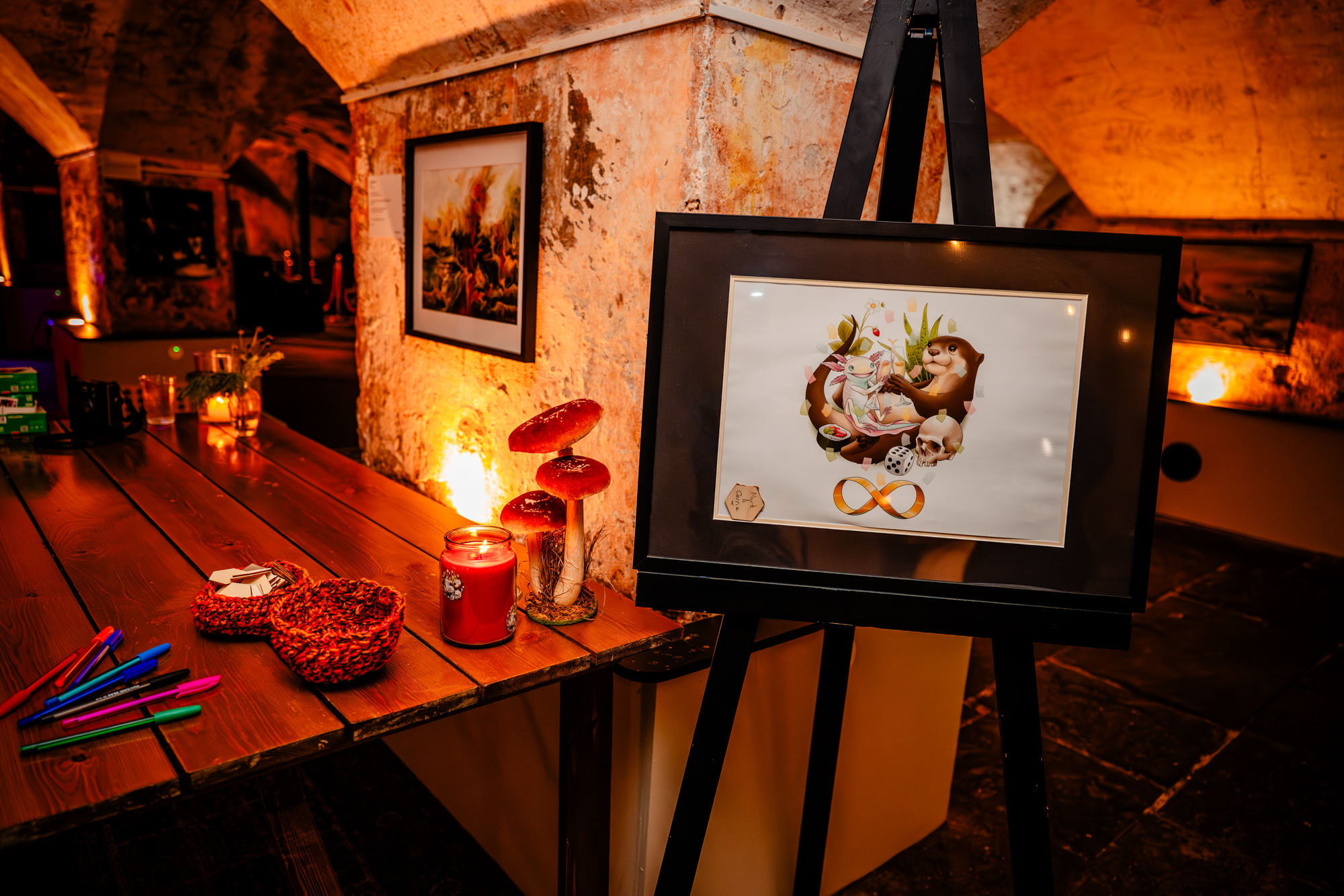 Framed illustrated wedding sign on an easel beside candles and guestbook table at The Mount Without in Bristol.