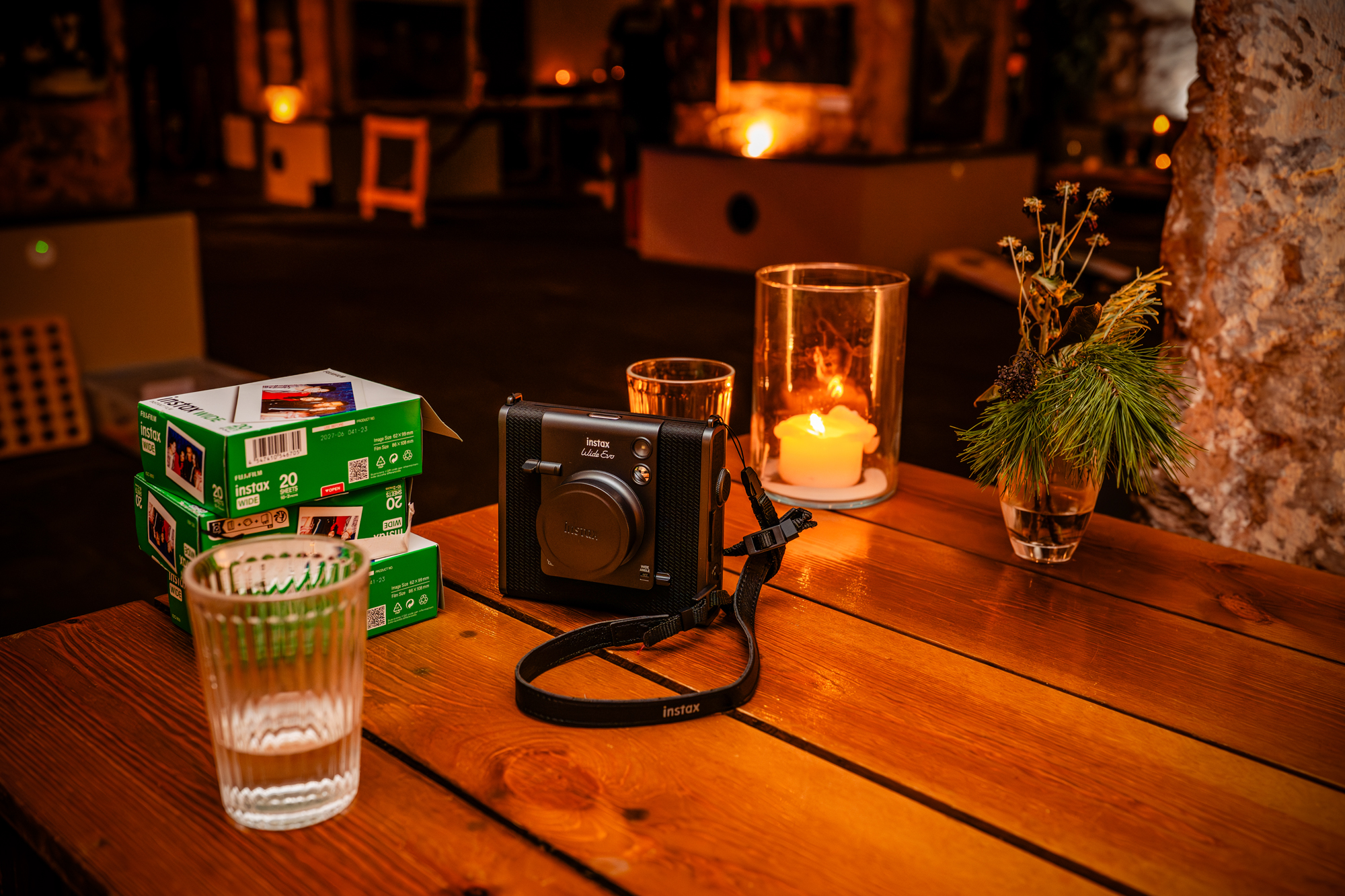 Instax camera with film packs and candles set up for guest photos at The Mount Without wedding in Bristol.