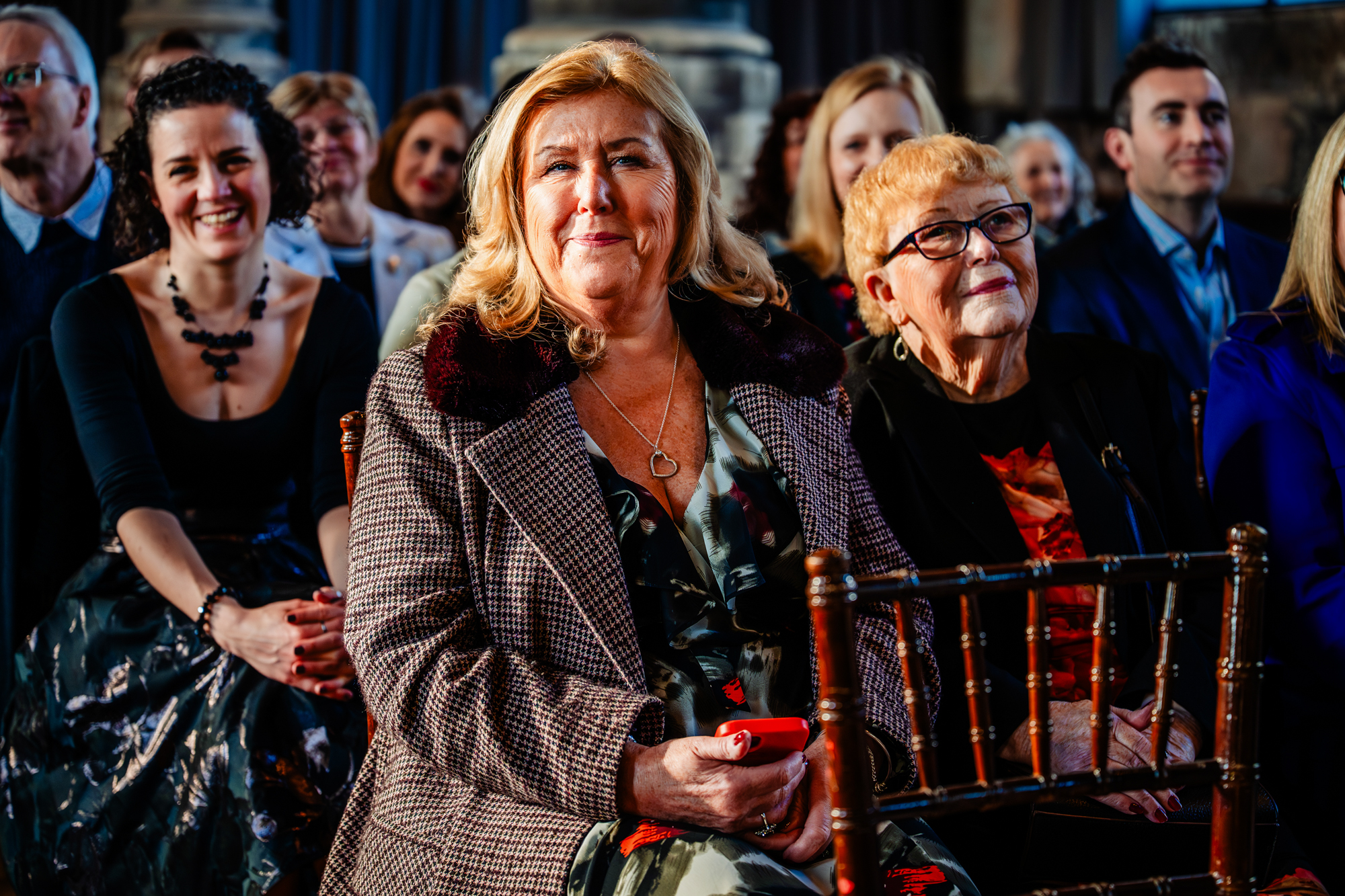 Emotional guests watching ceremony in warm natural light at Bristol wedding venue.