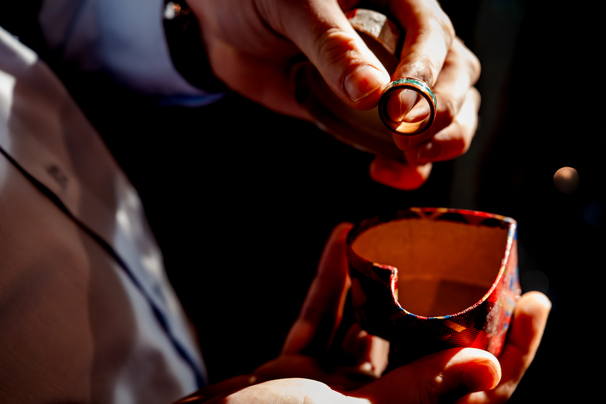 Wedding ring held in warm light during ceremony.
