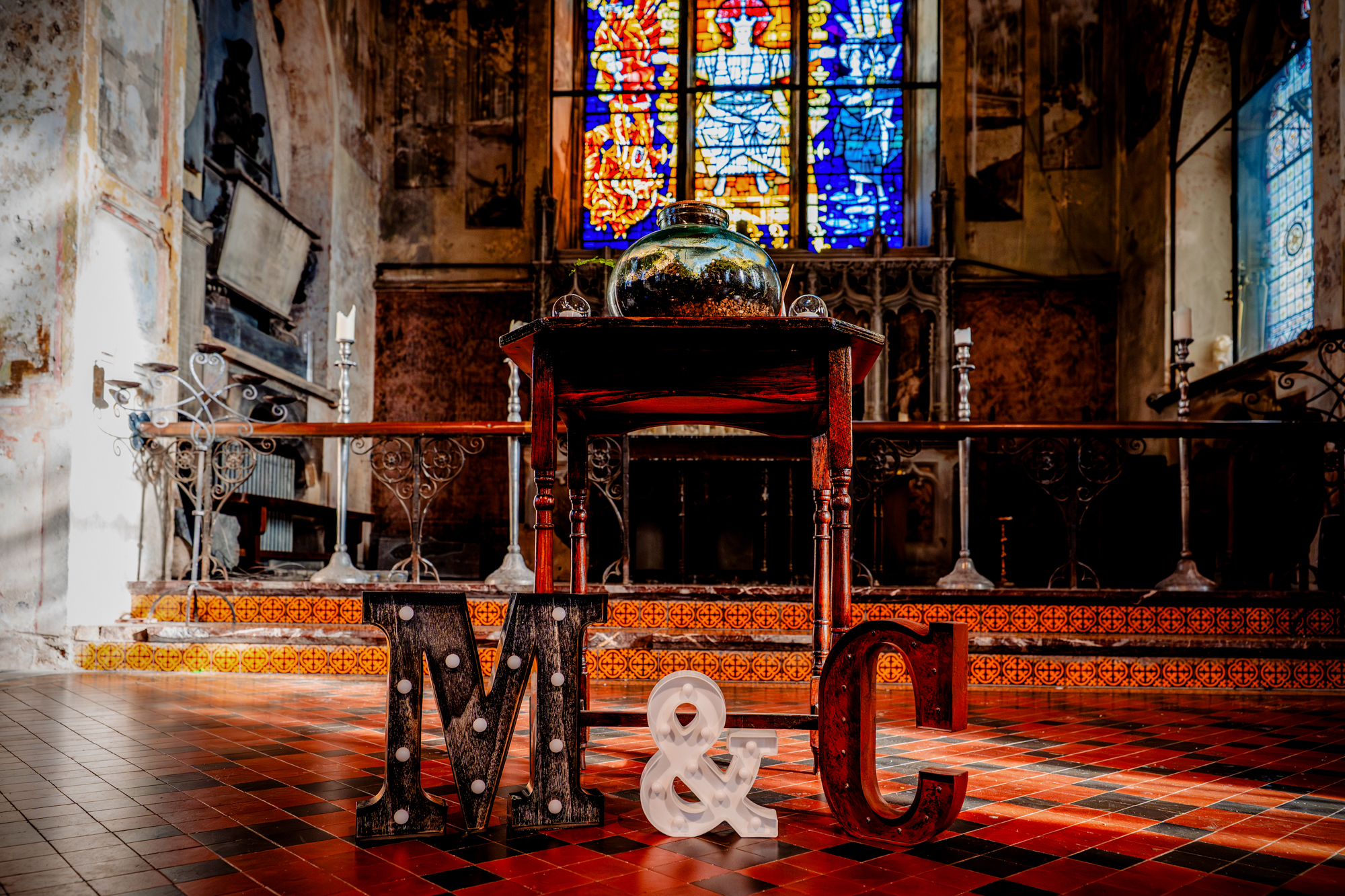 Ceremony setup with stained glass and terrarium altar at Mount Without Bristol wedding venue.