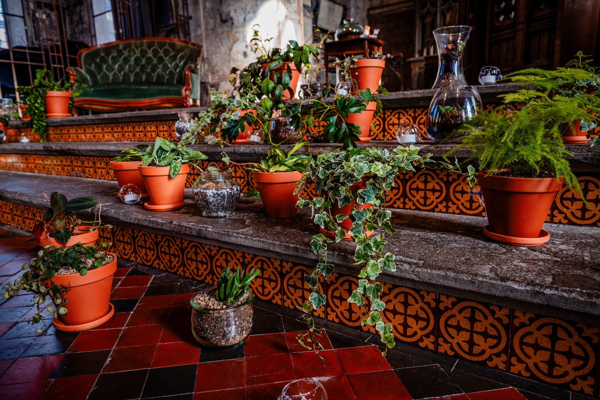 Indoor ceremony styling with potted plants and tiled steps at Mount Without Bristol.