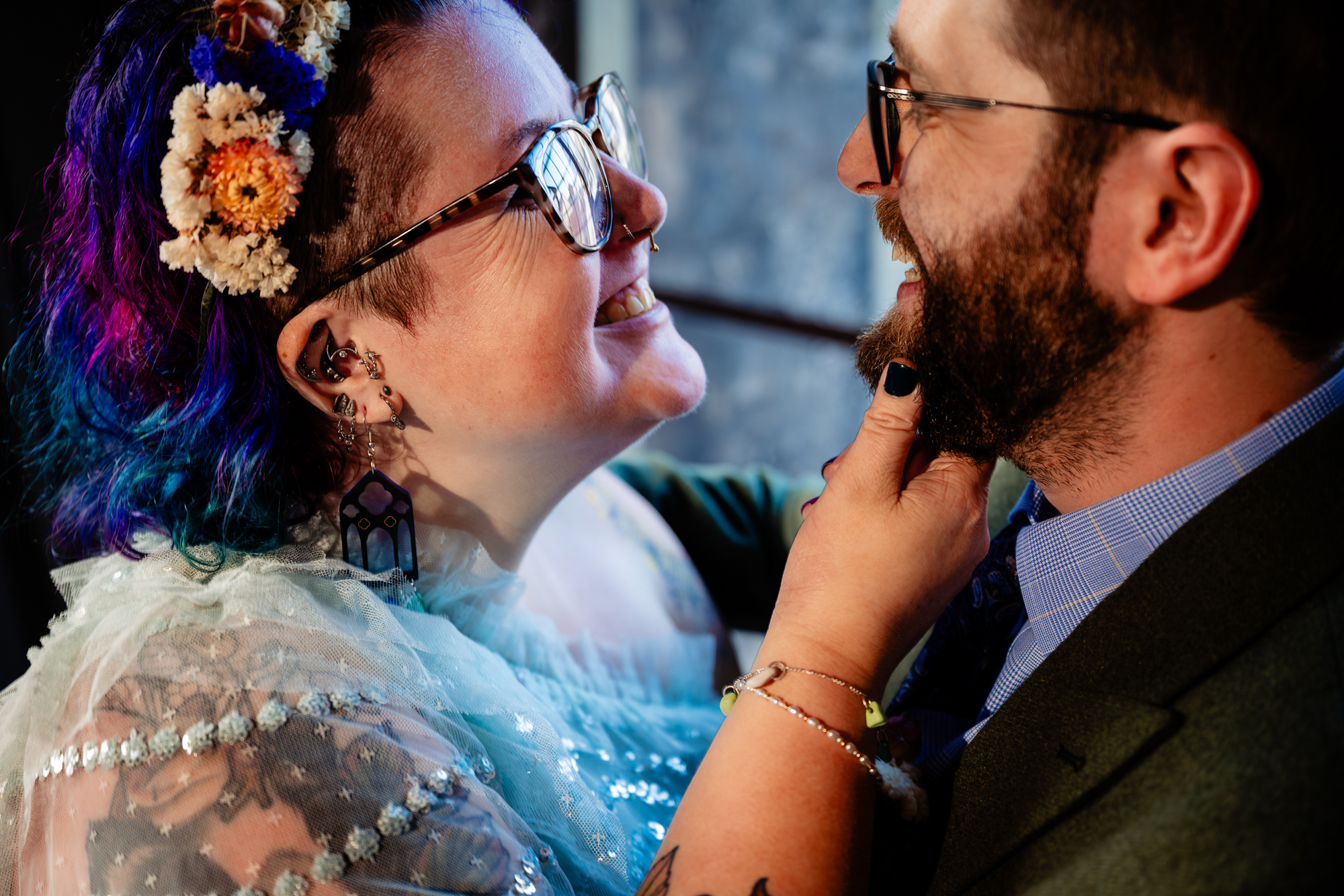 Close-up of couple smiling together during relaxed wedding portrait session in natural light.