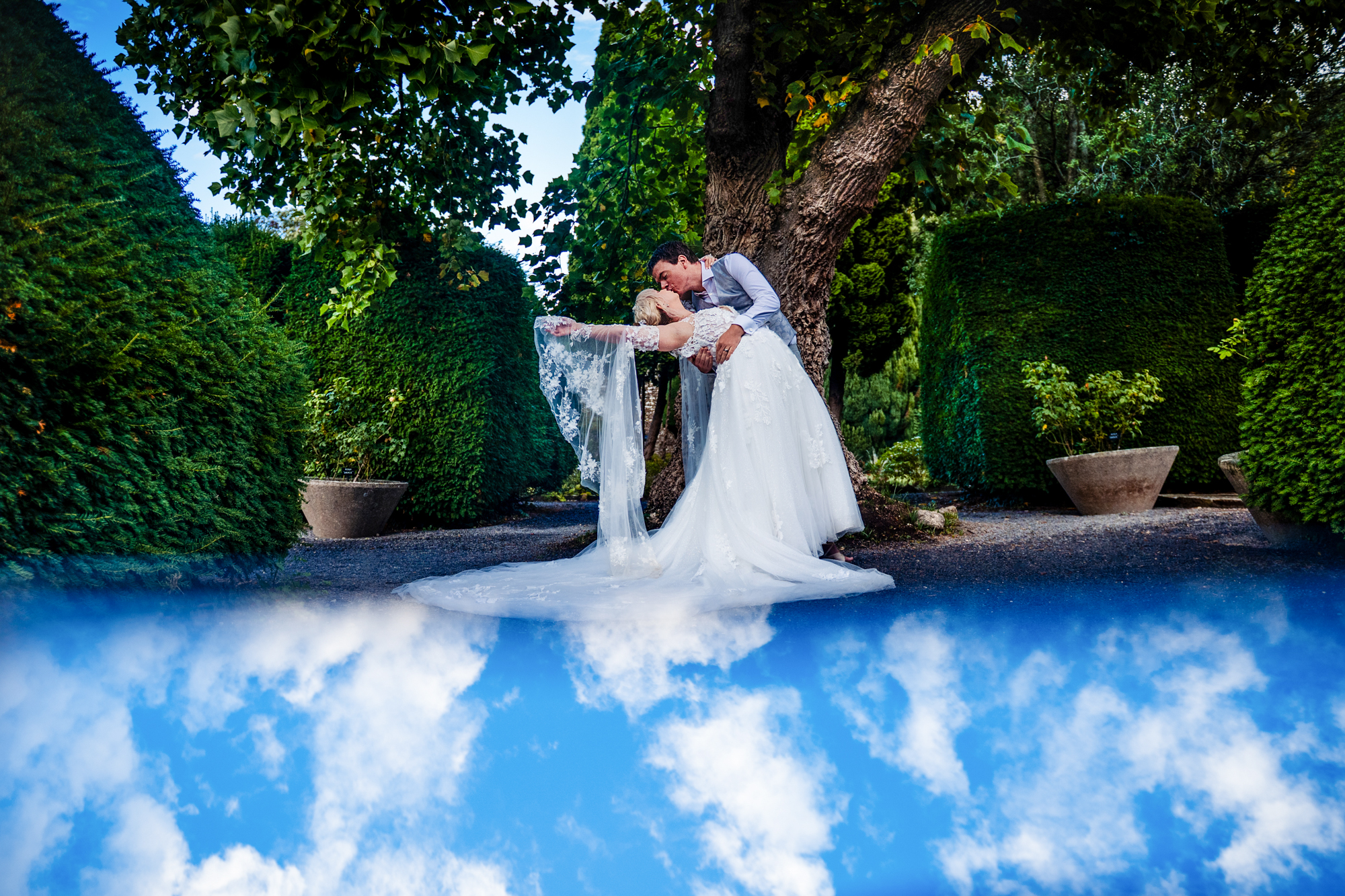 Creative portrait of Emma and Steve reflected against the sky during their anniversary session.