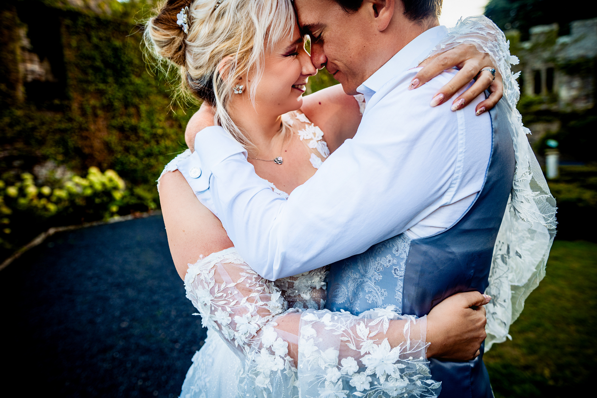 Close portrait of Emma and Steve embracing gently with soft expressions and natural light.