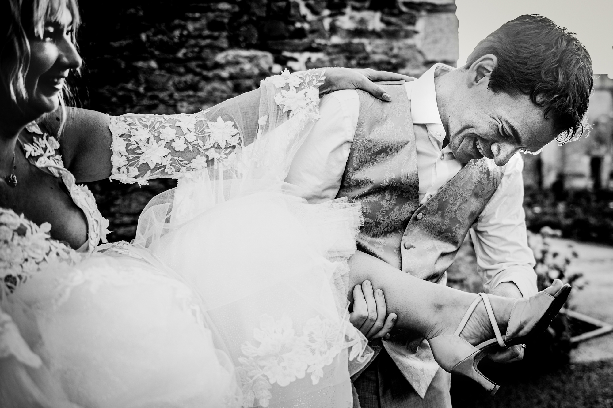 Emma smiles softly while standing close to Steve in a relaxed outdoor setting.