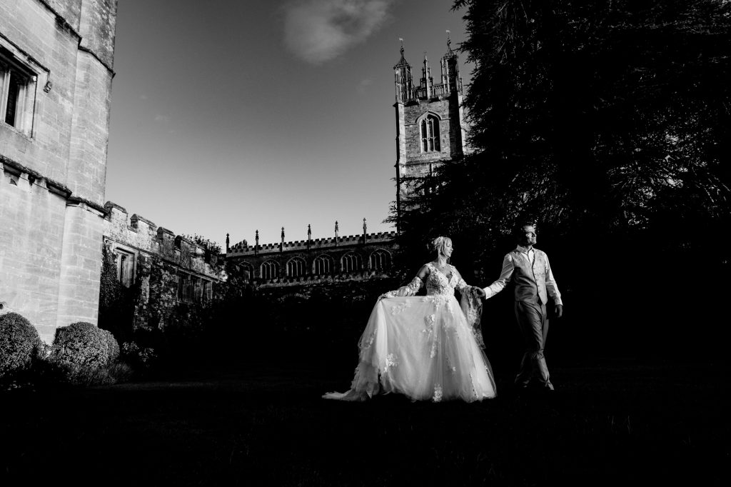 A couple walking across the castle grounds at Thornbury Castle.